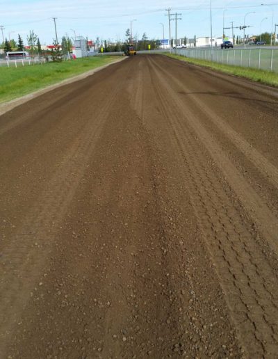 This picture shows a road with Enviro Gravel Seal (EGS) that is being re-bladed.
